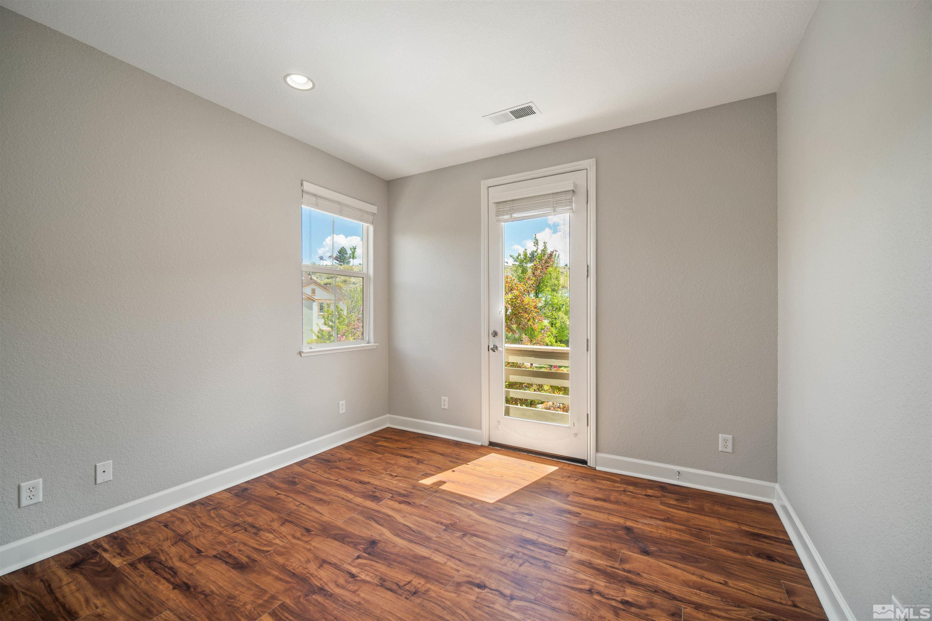 7609 Stone Bluff Way Reno, NV 89523 - Photo 35 of 40 an empty room with wooden floor and windows