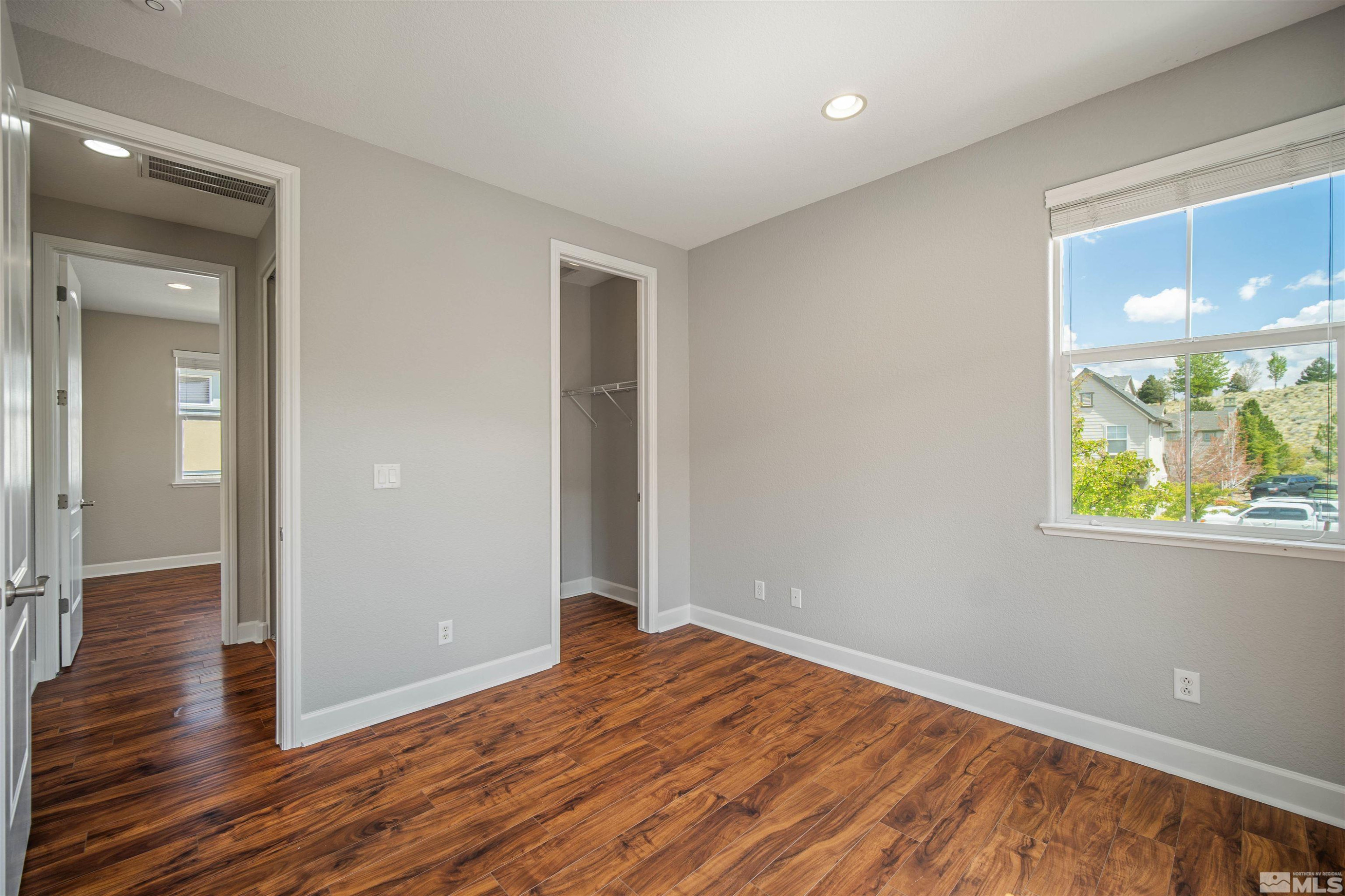 7609 Stone Bluff Way Reno, NV 89523 - Photo 36 of 40 wooden floor in an empty room with a window