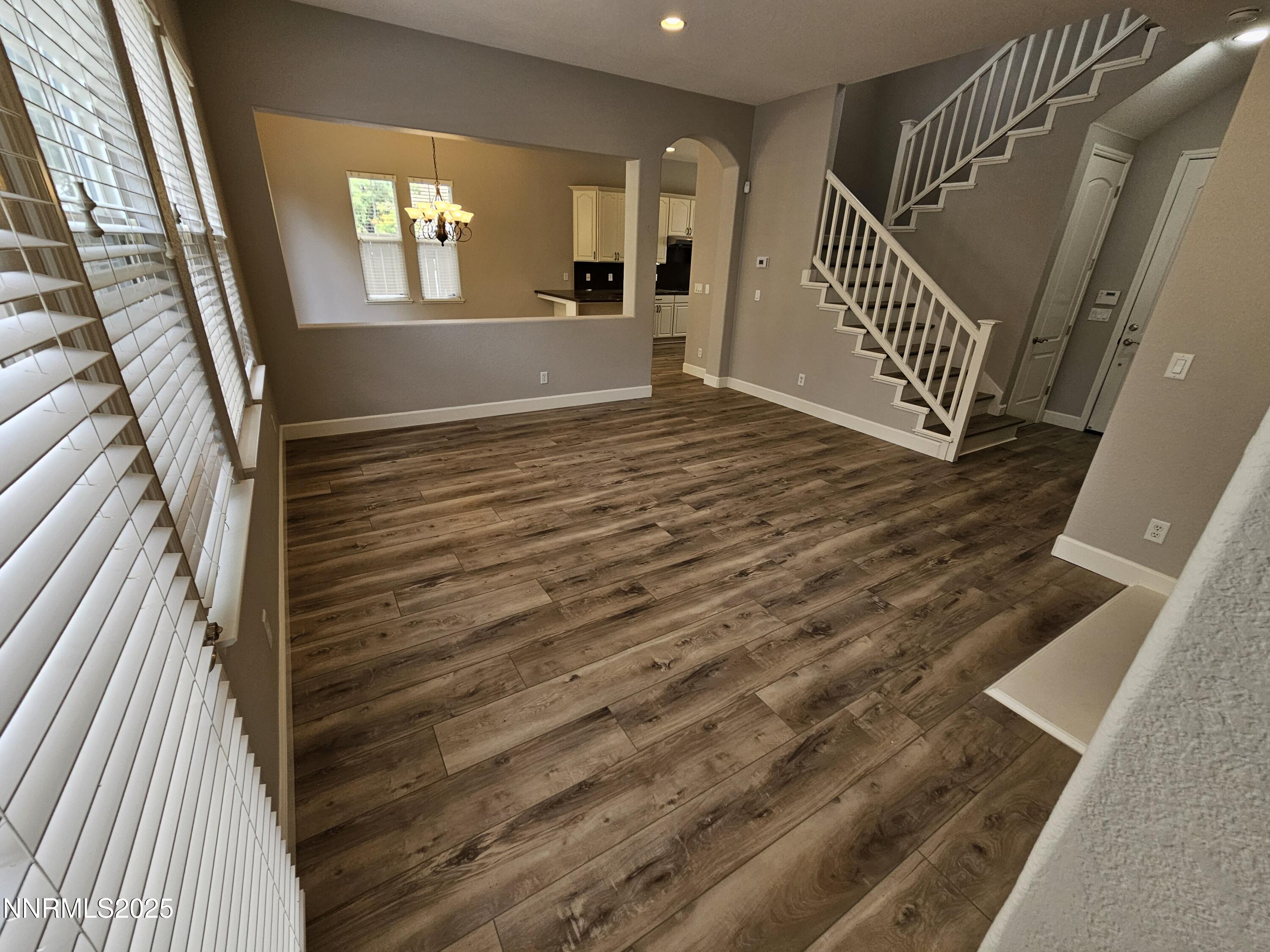 7609 Stone Bluff Way Reno, NV 89523 - Photo 5 of 40 a view of an empty room with wooden floor and a window
