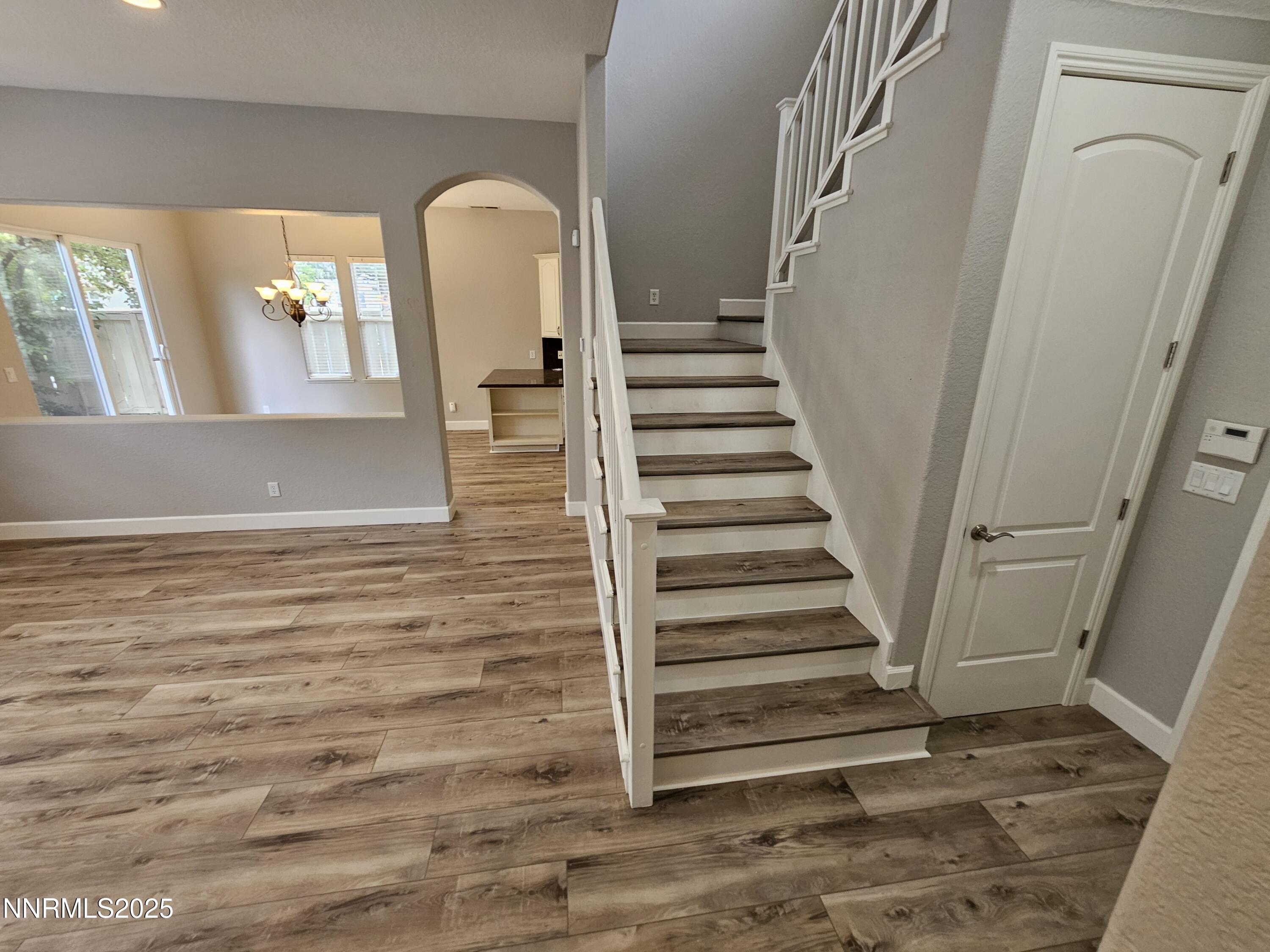 7609 Stone Bluff Way Reno, NV 89523 - Photo 8 of 40 a view of a livingroom with wooden floor and stairs