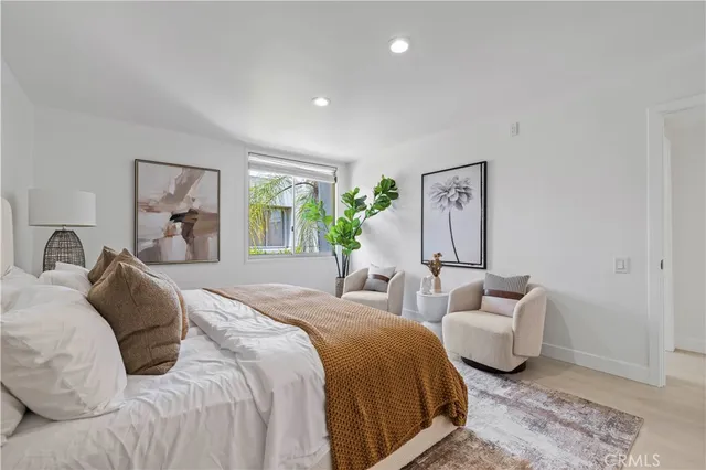 a spacious bedroom with a bed and a couch