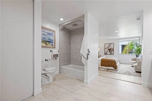 a living room with furniture and a painting on the wall