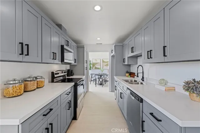 a kitchen with a sink a stove and cabinets