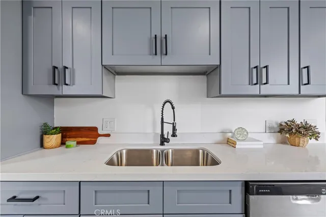 a kitchen with white cabinets and a sink