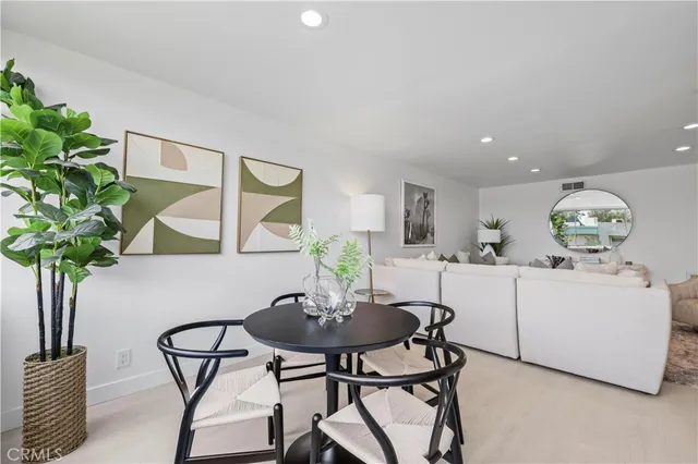 a view of a dining room with furniture and a potted plant