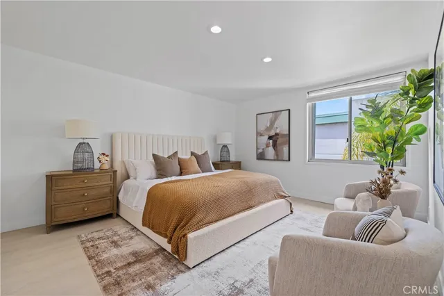 a spacious bedroom with a bed and a couch