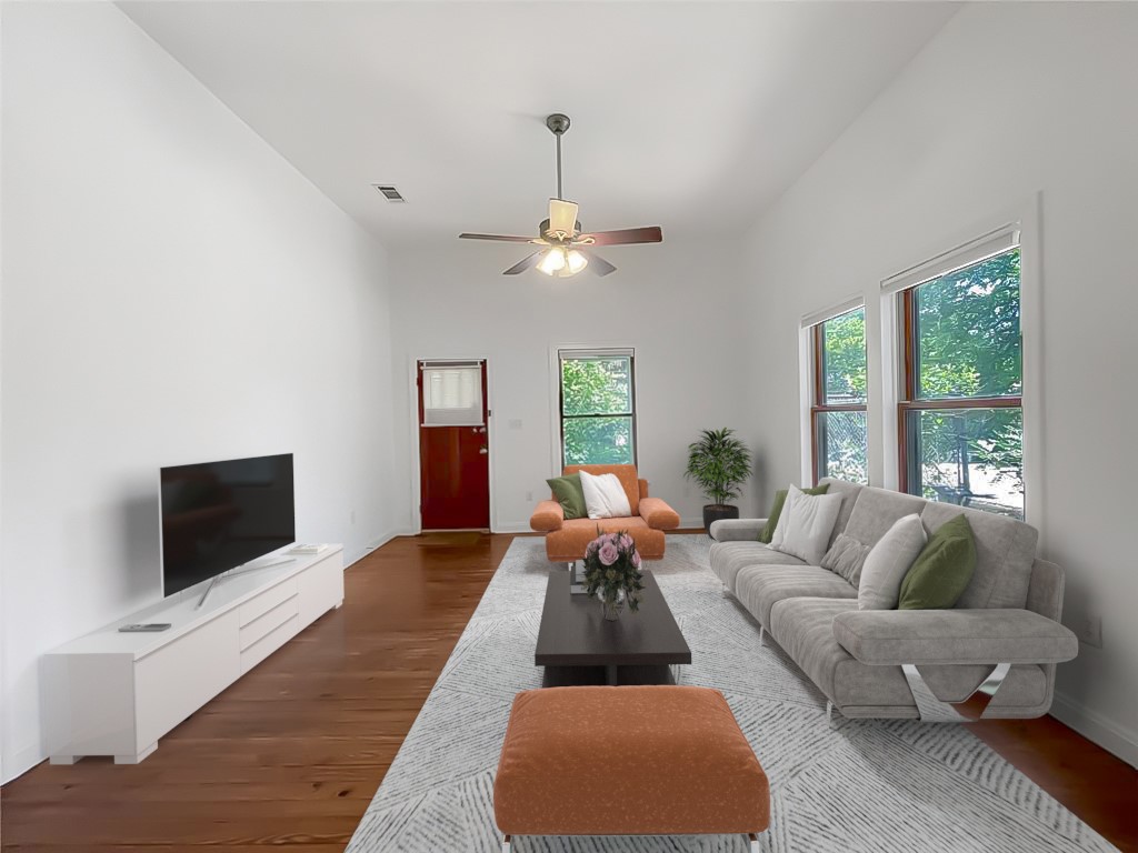 705 Waller Street Austin, TX 78702 - Photo 1 of 1 a living room with furniture a flat screen tv and a large window