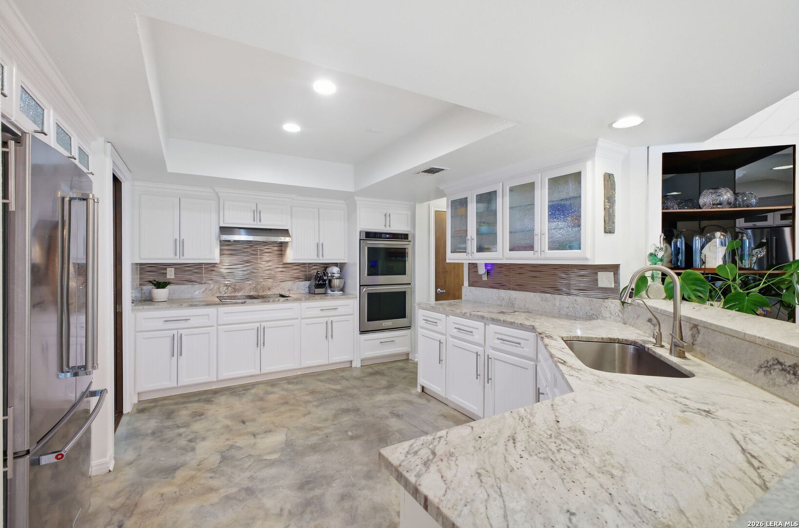 14502 Circle A Trail Helotes, TX 78023 - Photo 16 of 50 a large kitchen with stainless steel appliances granite countertop a sink refrigerator and cabinets