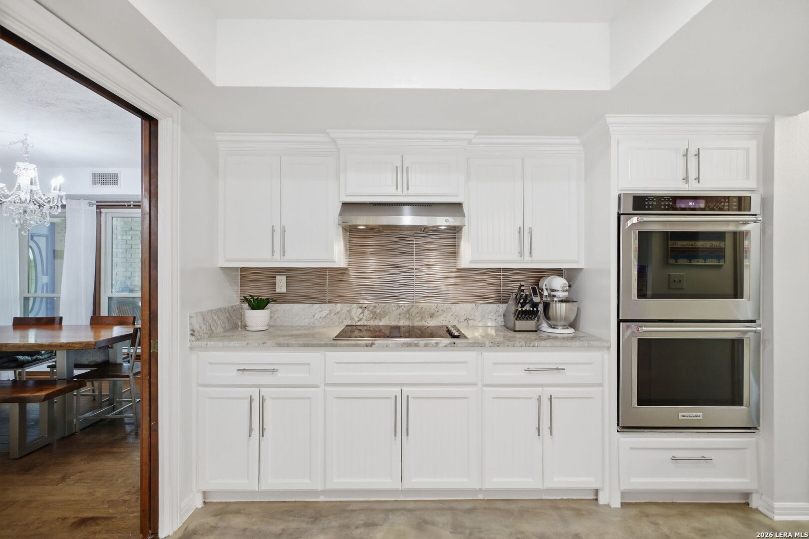 14502 Circle A Trail Helotes, TX 78023 - Photo 17 of 50 a kitchen with stainless steel appliances granite countertop a stove a sink and a microwave