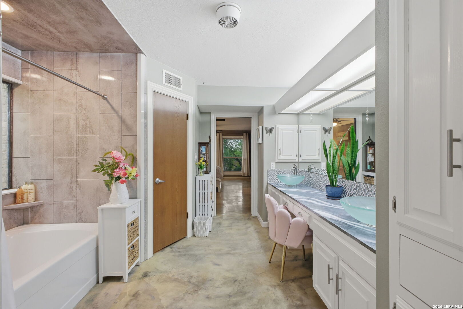 14502 Circle A Trail Helotes, TX 78023 - Photo 24 of 50 a bathroom with a granite countertop sink a mirror a bathtub and next to a window