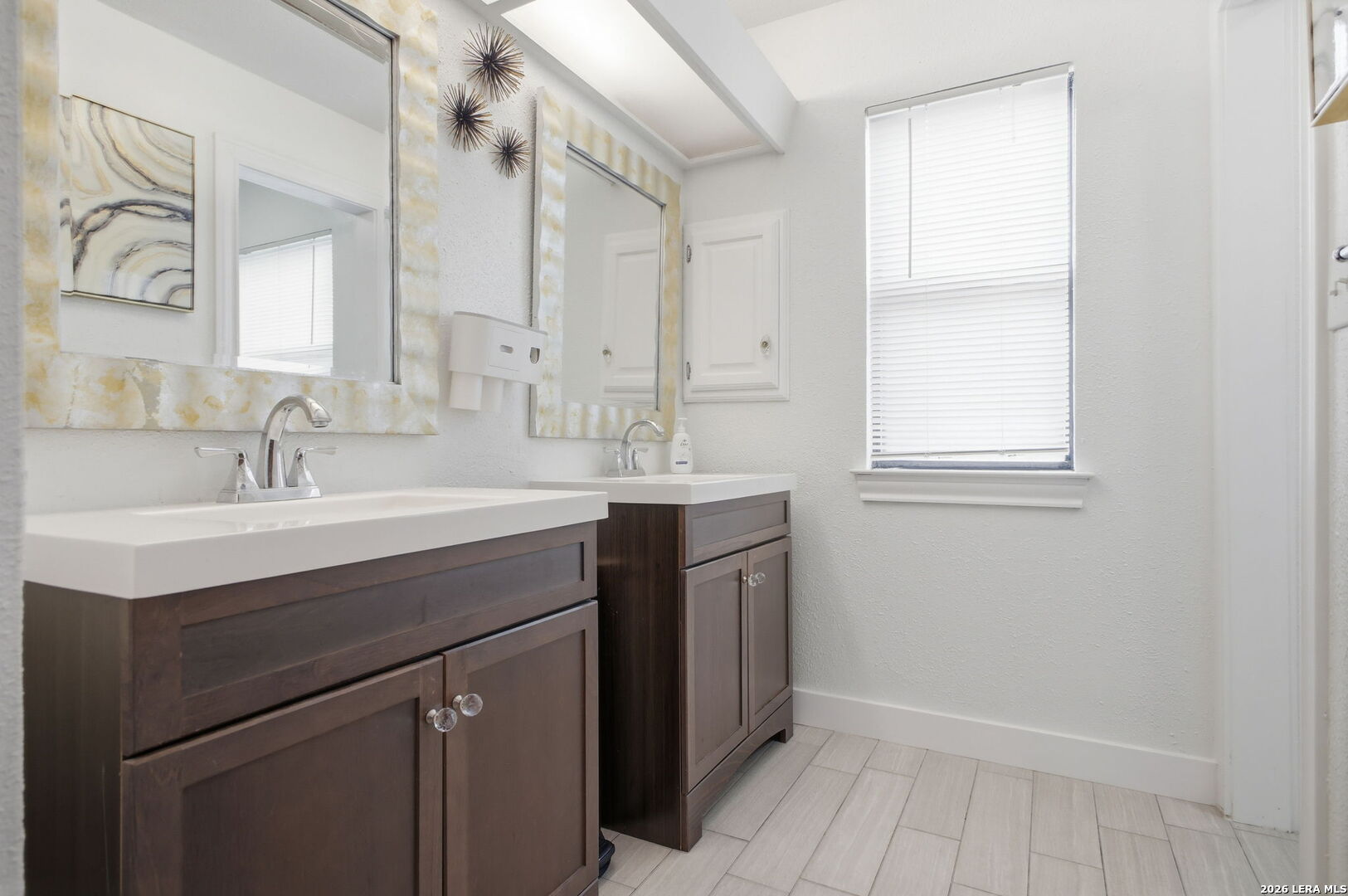 14502 Circle A Trail Helotes, TX 78023 - Photo 34 of 50 a bathroom with a sink vanity and a mirror