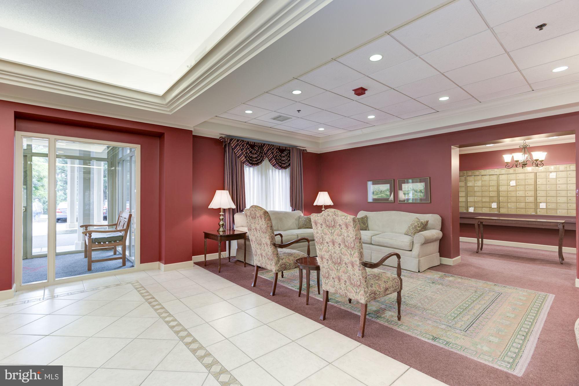 19385 Cypress Ridge Terrace, Unit 722 Leesburg, VA 20176 - Photo 5 of 10 a living room with furniture a large window and chandelier