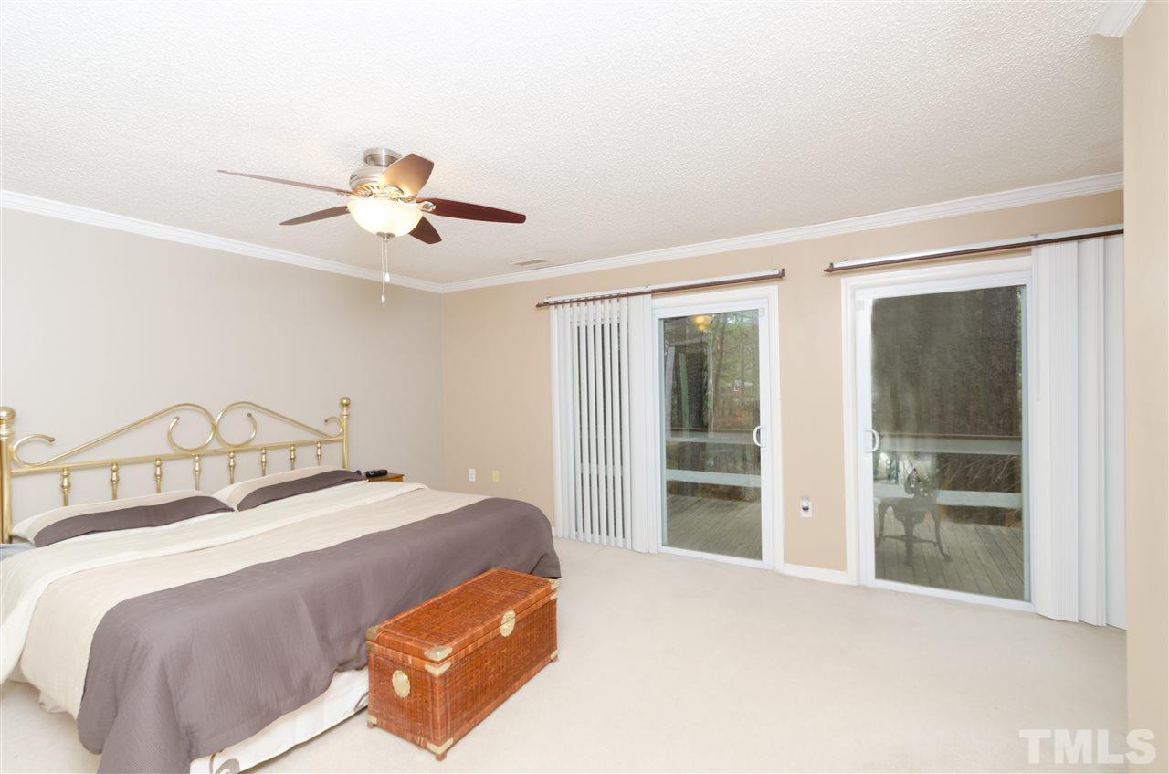 721 Locust Lane Raleigh, NC 27603 - Photo 13 of 22 a bedroom with a bed and a large window