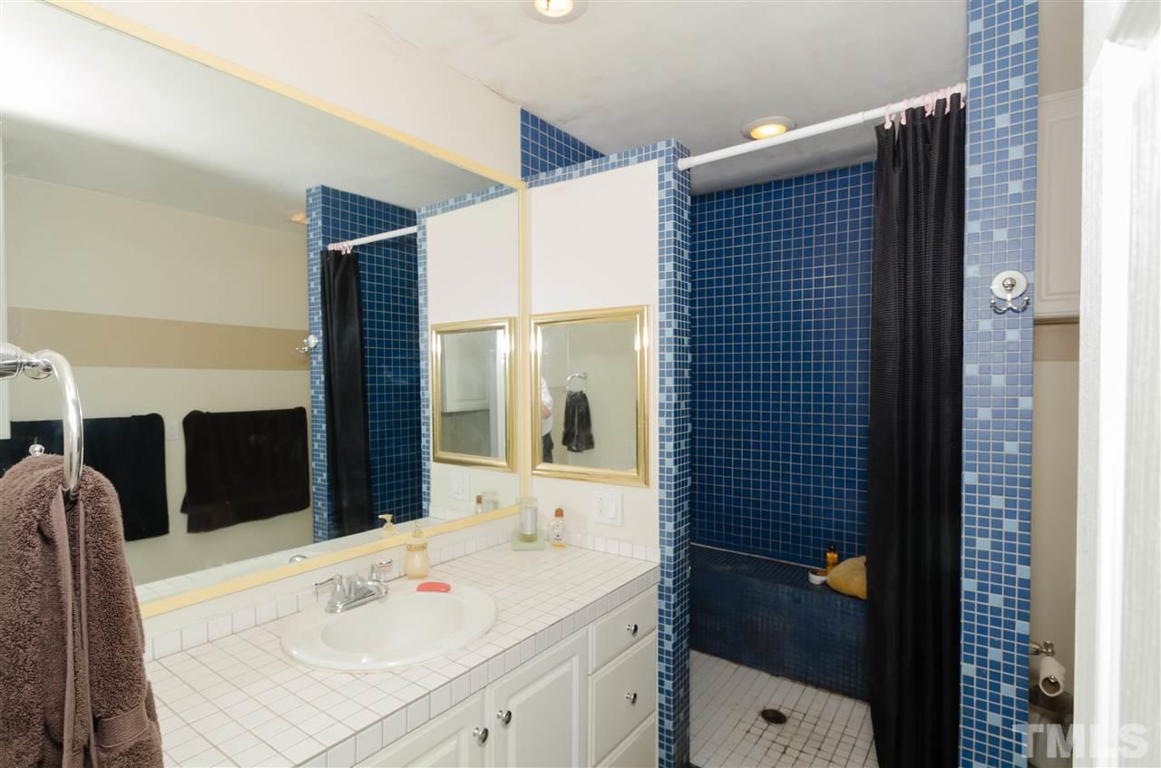 721 Locust Lane Raleigh, NC 27603 - Photo 17 of 22 a bathroom with a sink and a mirror