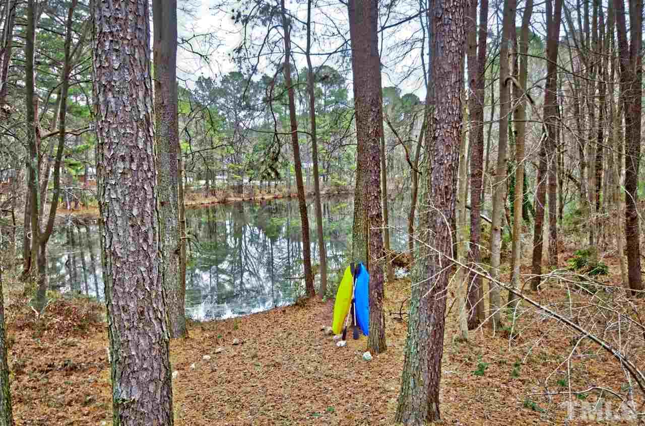 721 Locust Lane Raleigh, NC 27603 - Photo 21 of 22 a view of tall trees and a small yard