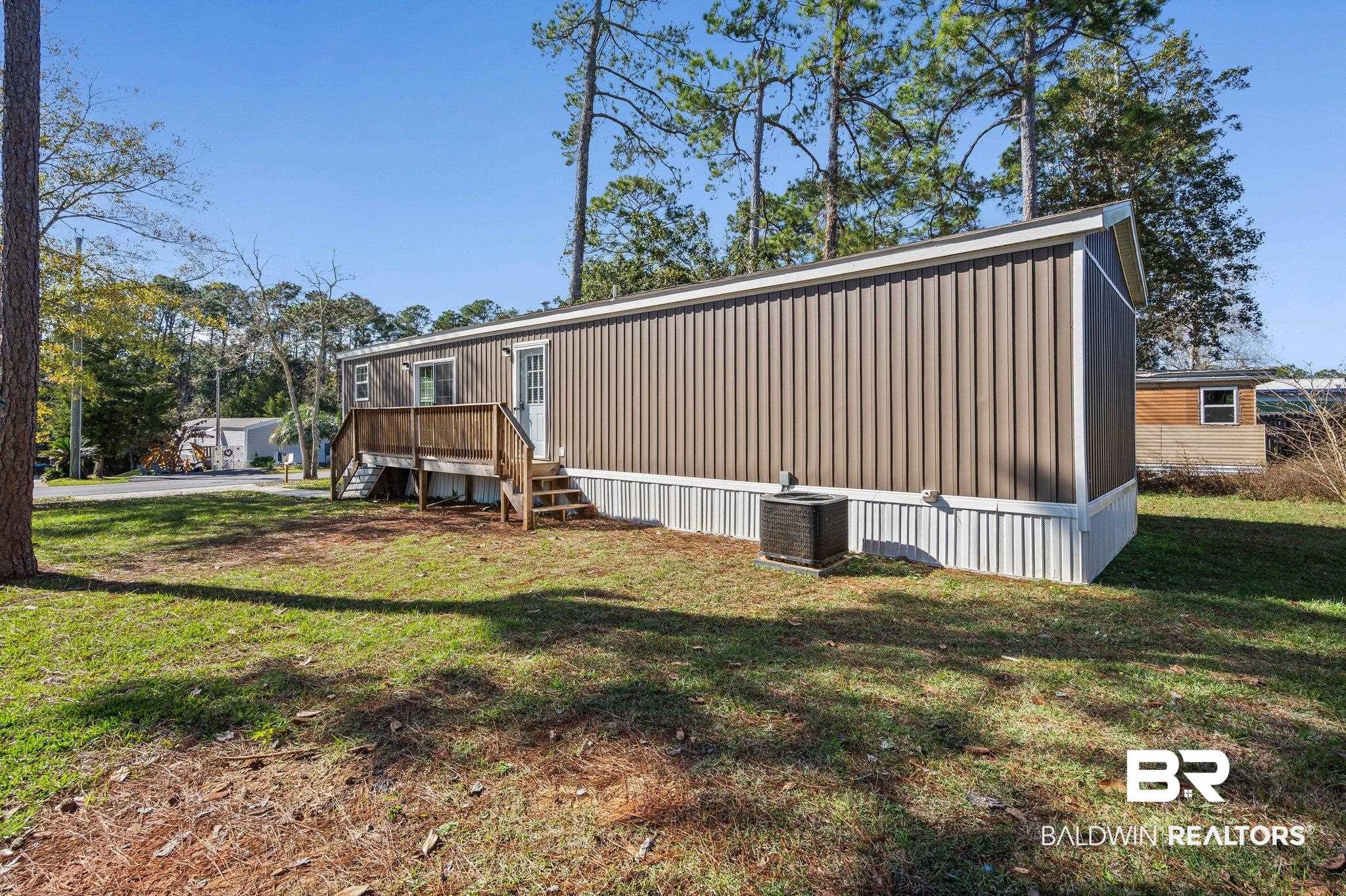 1325 Ridgewood Drive Lillian, AL 36549 - Photo 18 of 32 Back of house featuring stairway and a lawn