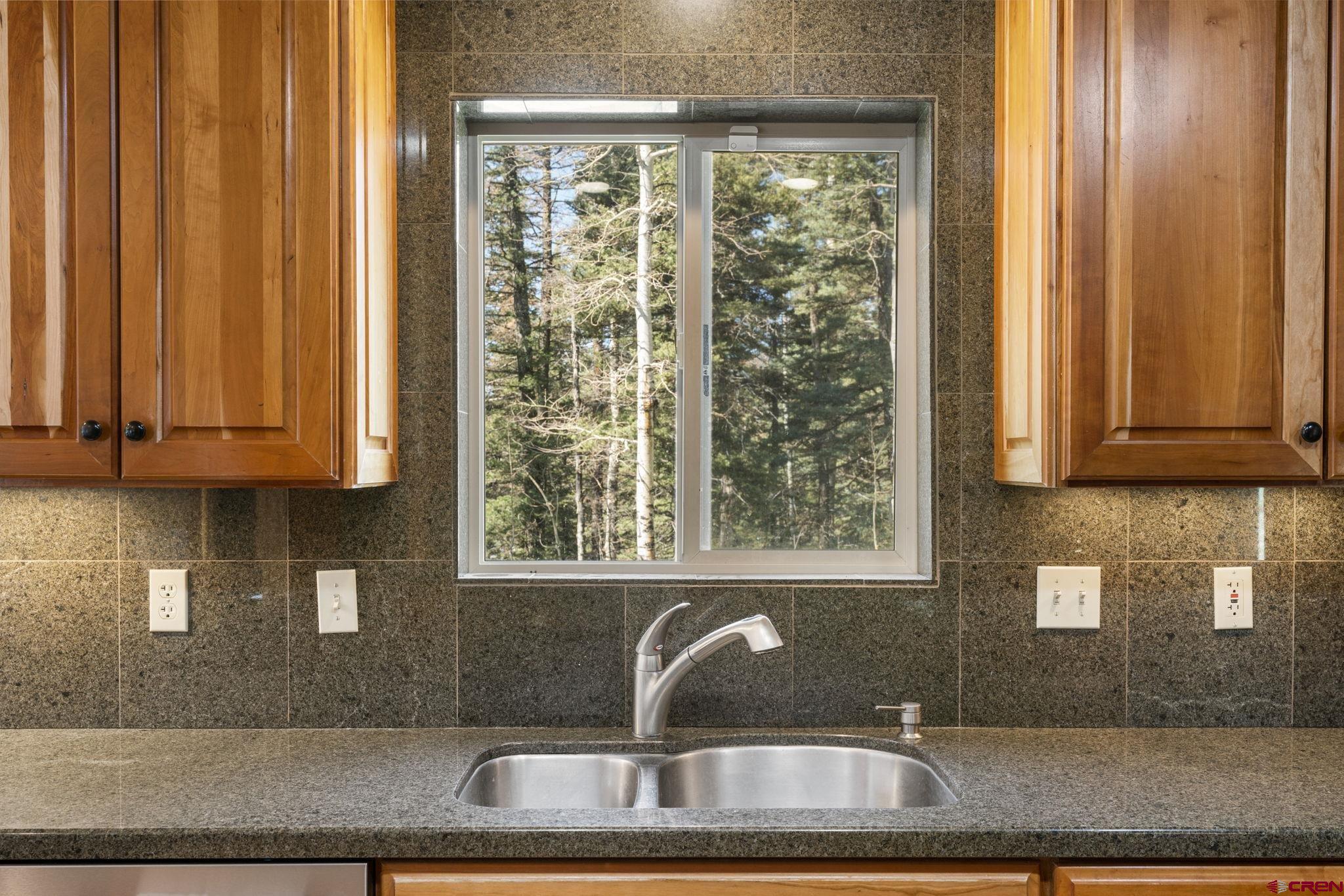 29 Eckart Lane Durango, CO 81301 - Photo 11 of 34 a kitchen with stainless steel appliances granite countertop a sink and a window