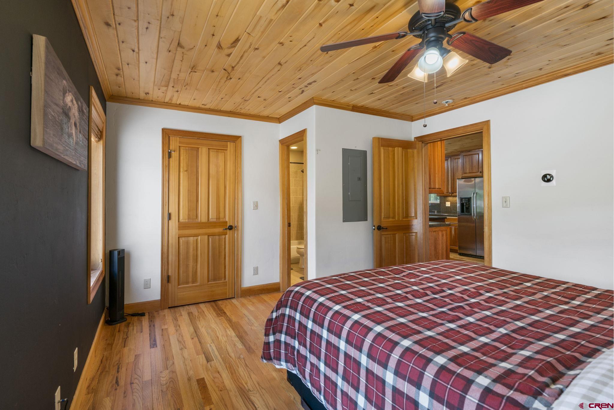29 Eckart Lane Durango, CO 81301 - Photo 17 of 34 a bedroom with a bed and a chandelier