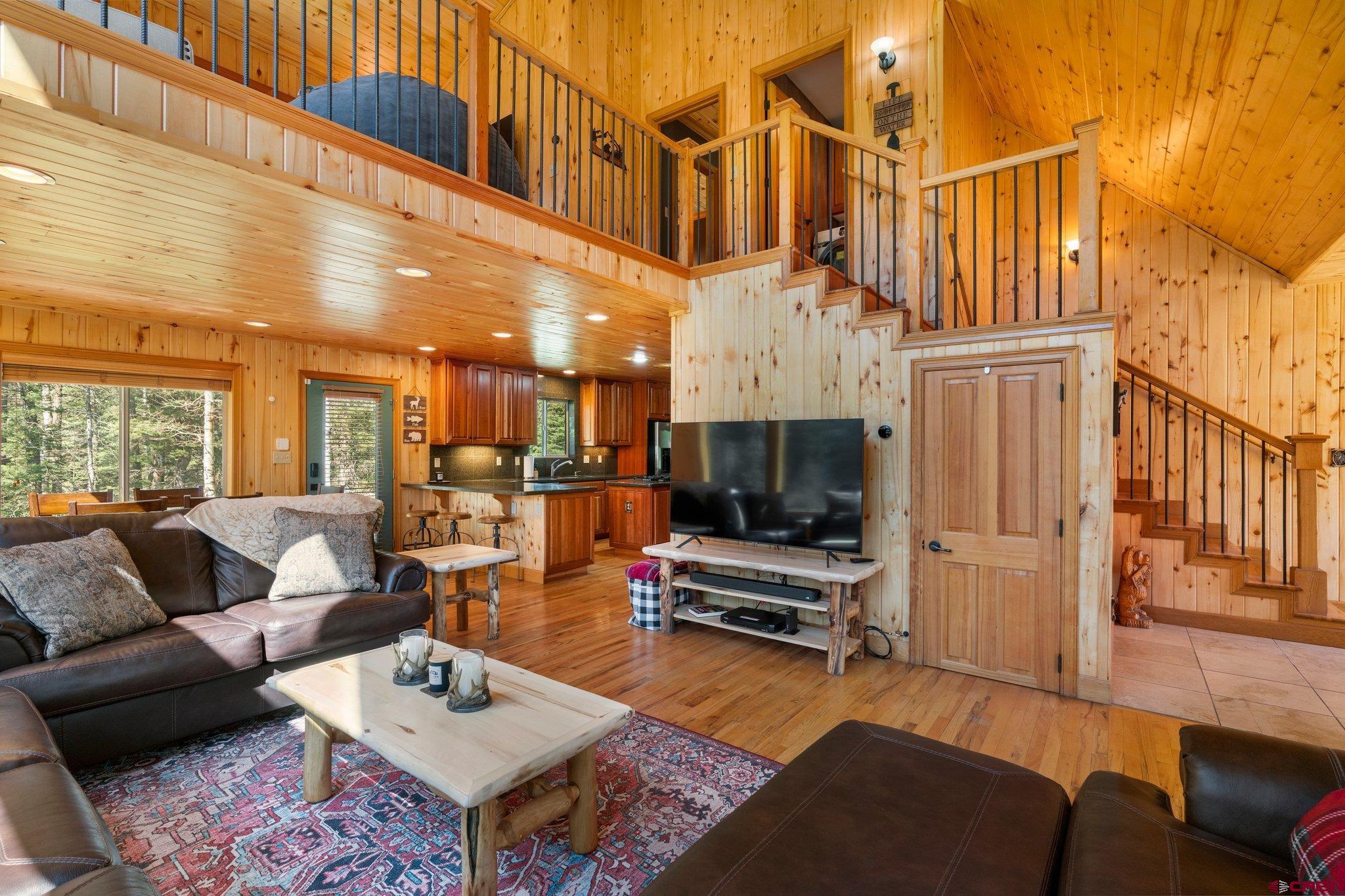 29 Eckart Lane Durango, CO 81301 - Photo 3 of 34 a living room with furniture a flat screen tv and kitchen view