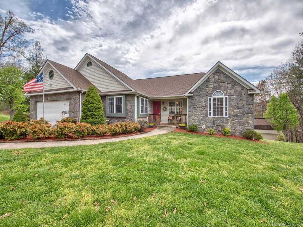 208 Oak Ridge Drive Clyde, NC 28721 - Photo 1 of 36 a front view of a house with a garden