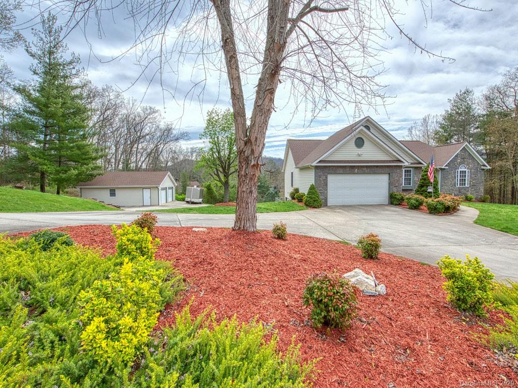 208 Oak Ridge Drive Clyde, NC 28721 - Photo 2 of 36 a front view of a house with a yard and garage