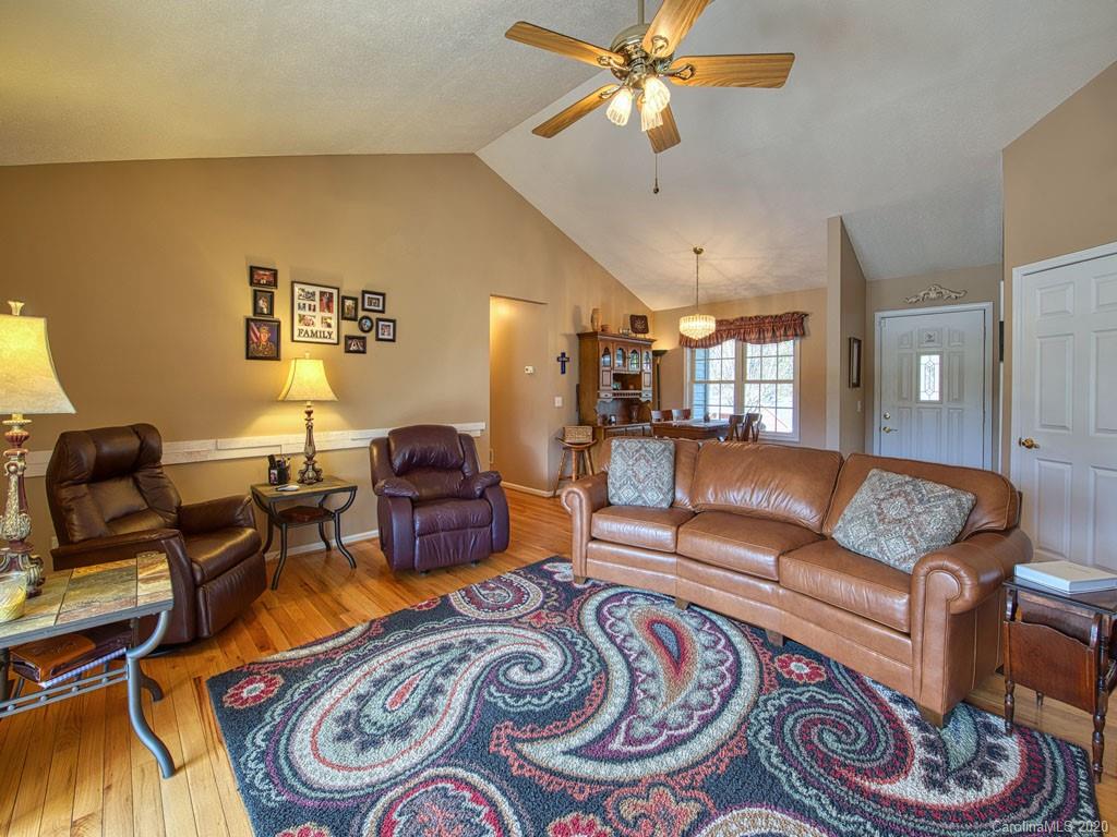 208 Oak Ridge Drive Clyde, NC 28721 - Photo 11 of 36 a living room with furniture and a chandelier