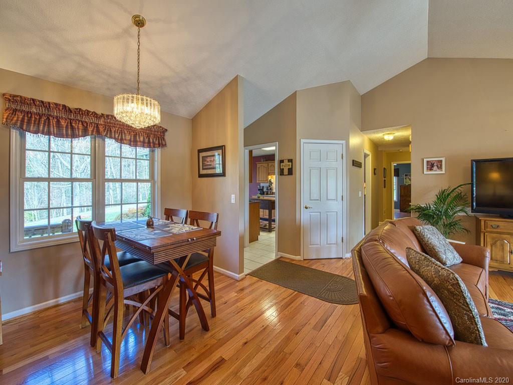 208 Oak Ridge Drive Clyde, NC 28721 - Photo 12 of 36 a view of a dining room with furniture window and wooden floor
