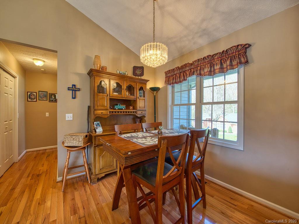 208 Oak Ridge Drive Clyde, NC 28721 - Photo 13 of 36 a view of a dining room with furniture window and wooden floor