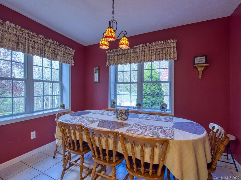 208 Oak Ridge Drive Clyde, NC 28721 - Photo 17 of 36 a view of a dining room with furniture and chandelier