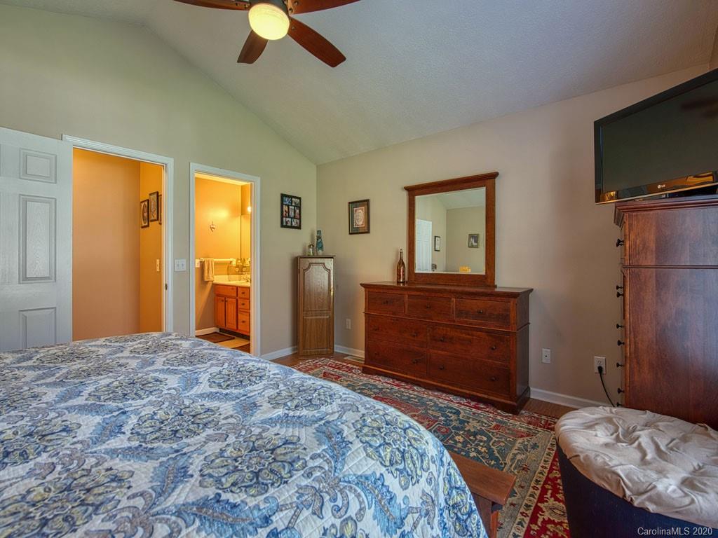 208 Oak Ridge Drive Clyde, NC 28721 - Photo 20 of 36 a bedroom with a bed and a dresser in it
