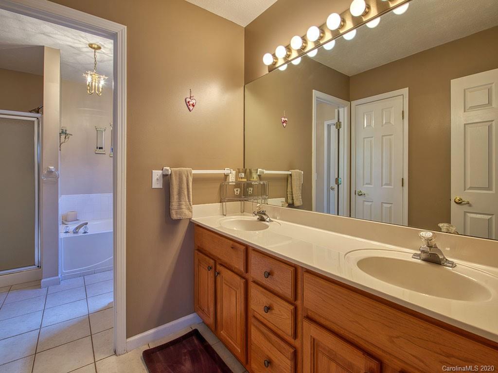 208 Oak Ridge Drive Clyde, NC 28721 - Photo 21 of 36 a bathroom with a sink double vanity and a mirror