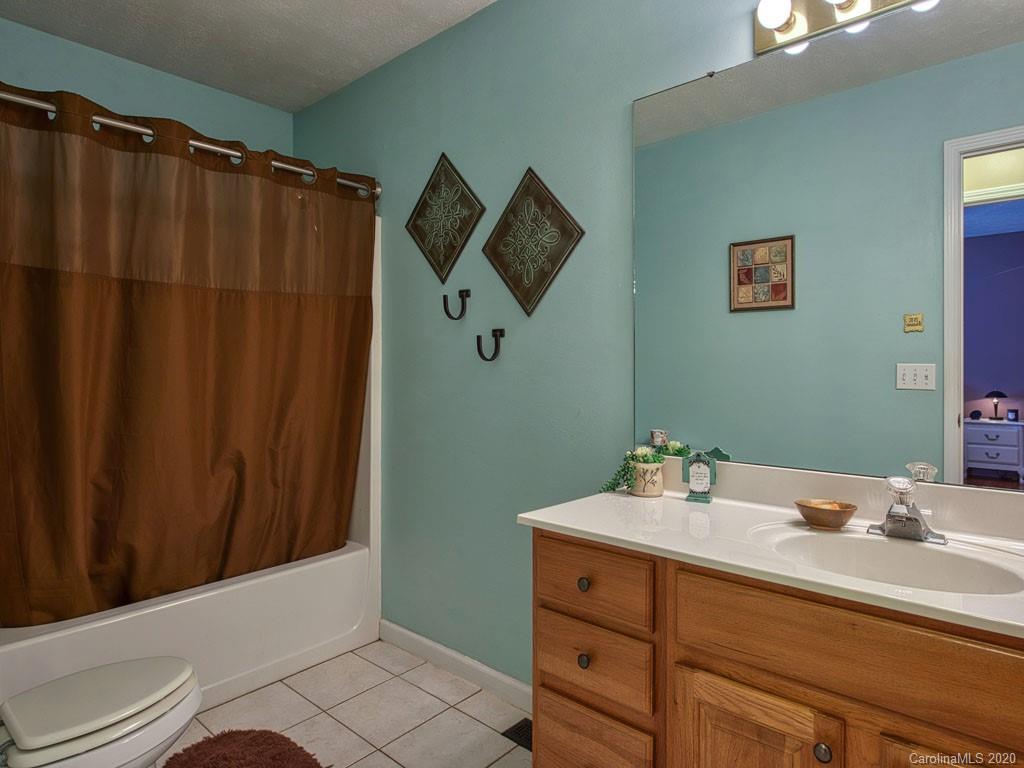 208 Oak Ridge Drive Clyde, NC 28721 - Photo 26 of 36 a bathroom with a sink and a mirror