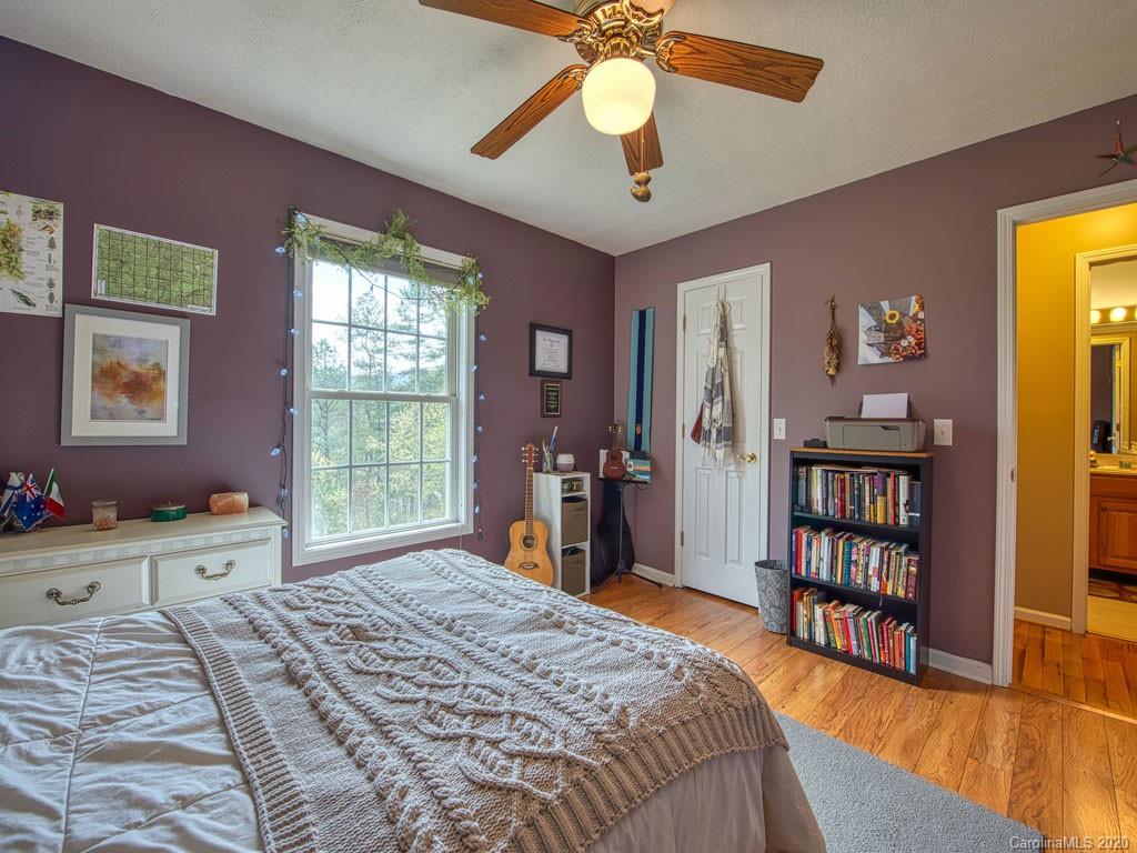 208 Oak Ridge Drive Clyde, NC 28721 - Photo 29 of 36 a bed room with a bed and a bookshelf