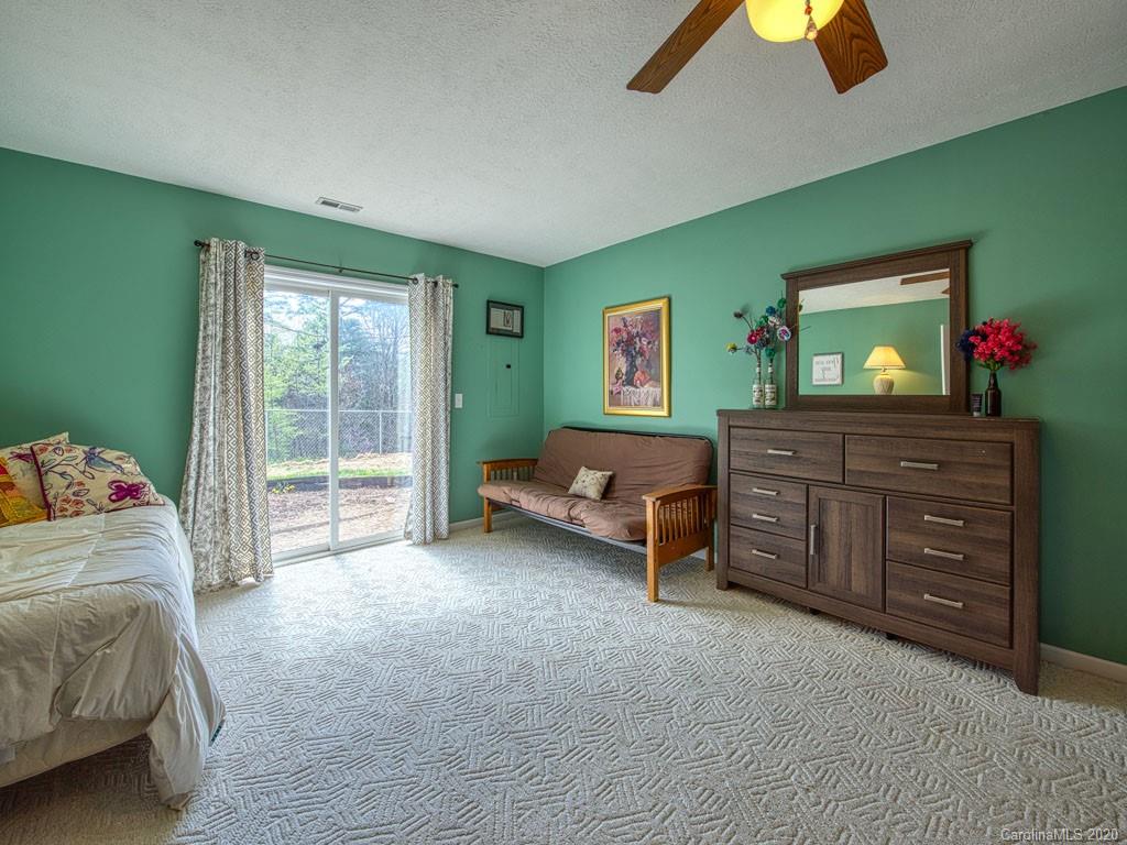 208 Oak Ridge Drive Clyde, NC 28721 - Photo 34 of 36 a bedroom with a bed and a cabinets