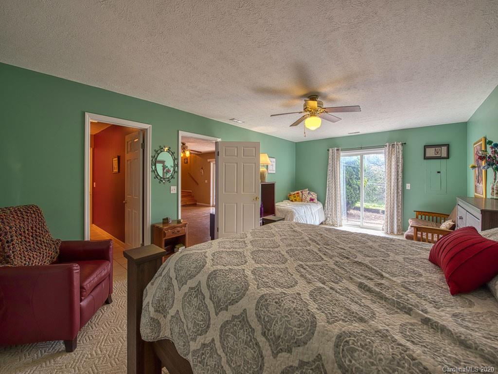 208 Oak Ridge Drive Clyde, NC 28721 - Photo 35 of 36 a bed room with a bed and a couch