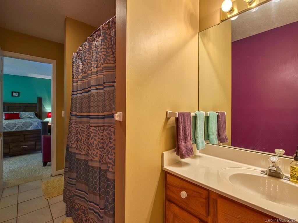 208 Oak Ridge Drive Clyde, NC 28721 - Photo 36 of 36 a bathroom with a sink vanity and a mirror