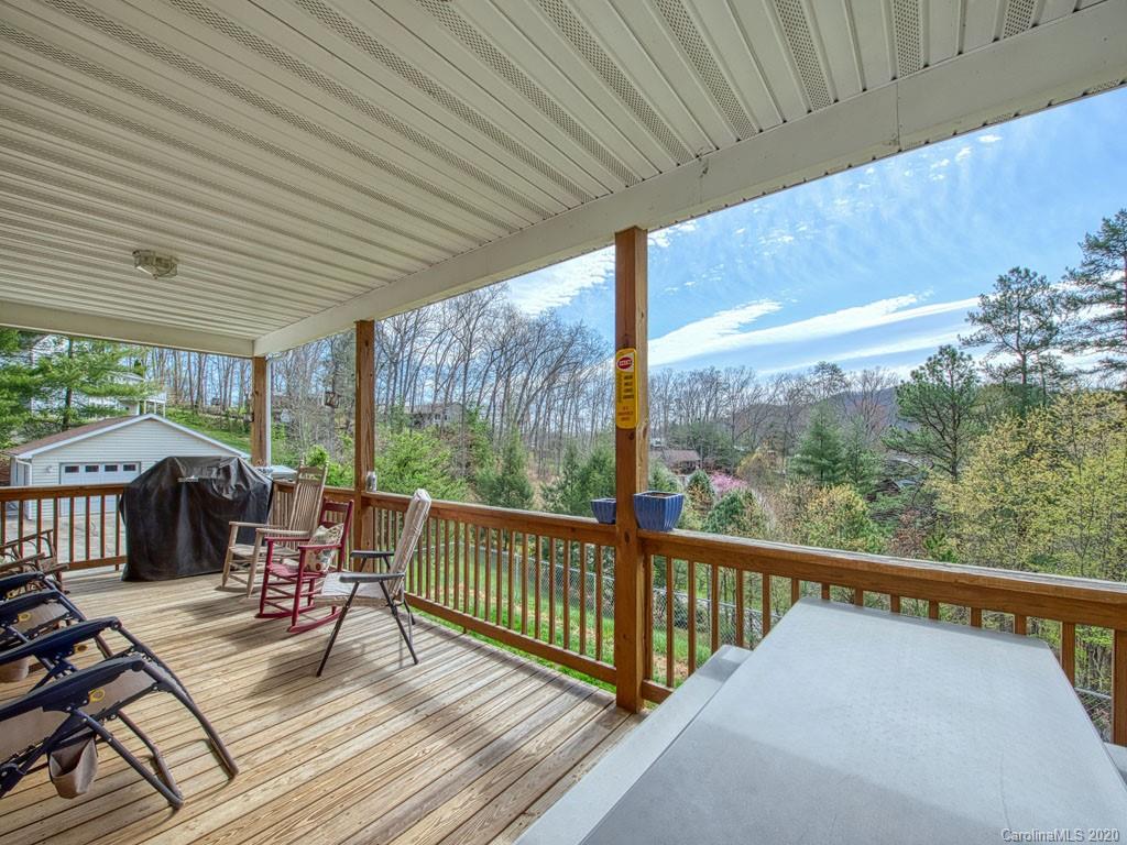208 Oak Ridge Drive Clyde, NC 28721 - Photo 6 of 36 a view of a balcony with chairs and wooden floor
