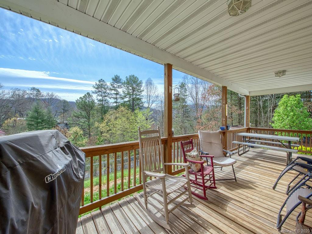 208 Oak Ridge Drive Clyde, NC 28721 - Photo 7 of 36 a balcony with wooden floor and outdoor seating