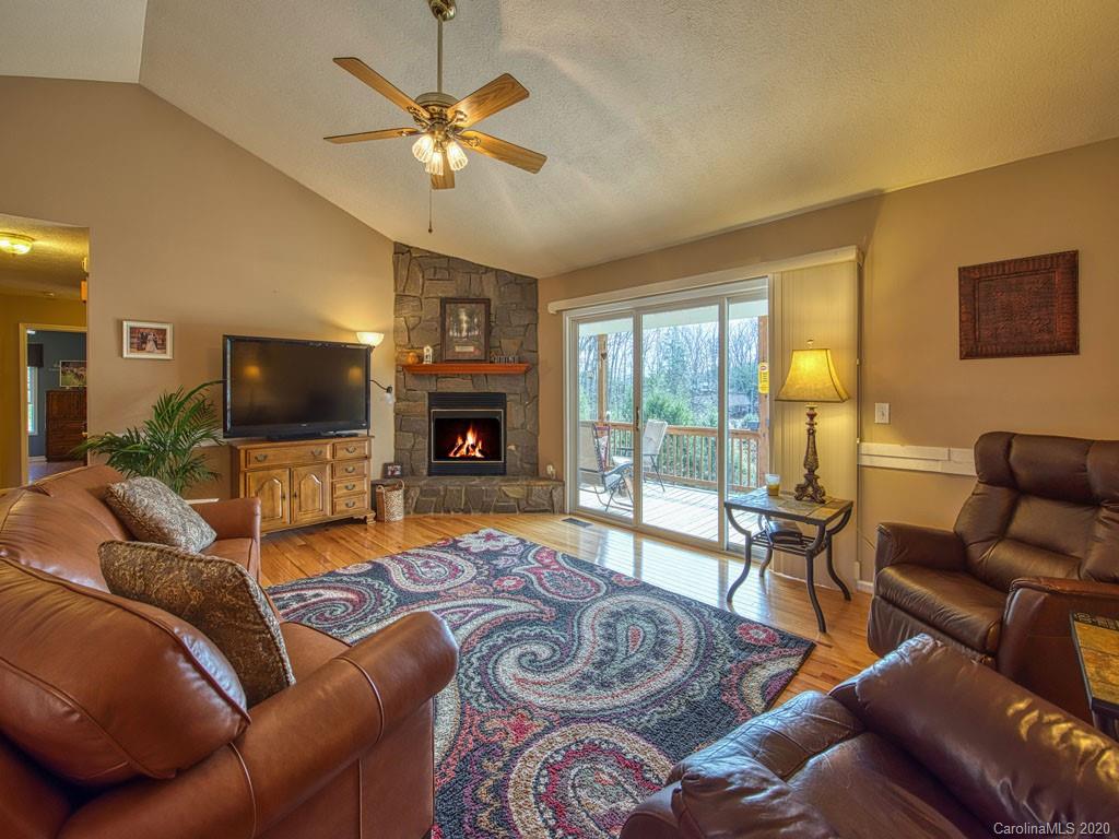 208 Oak Ridge Drive Clyde, NC 28721 - Photo 9 of 36 a living room with furniture a flat screen tv and a large window