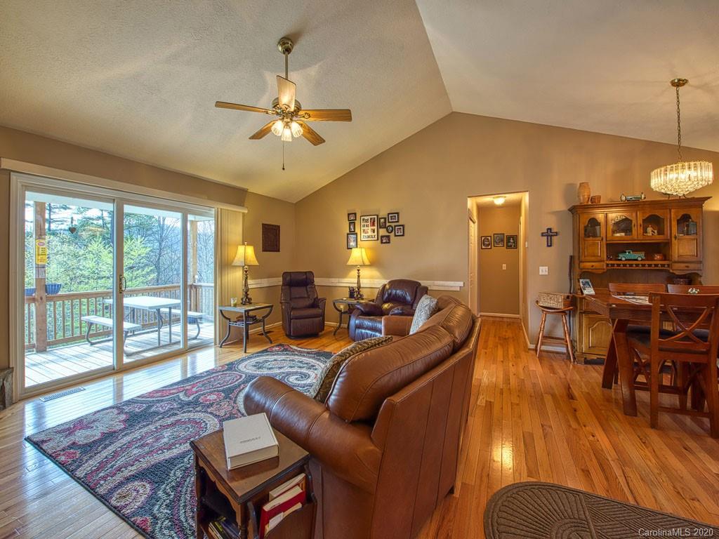 208 Oak Ridge Drive Clyde, NC 28721 - Photo 10 of 36 a living room with furniture a fireplace and a table