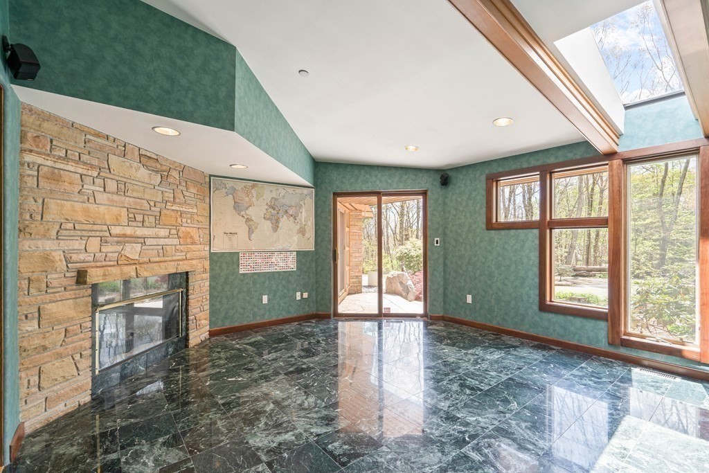 44 Sears Road Southborough, MA 01772 - Photo 19 of 41 a view of an empty room with a fireplace and a window