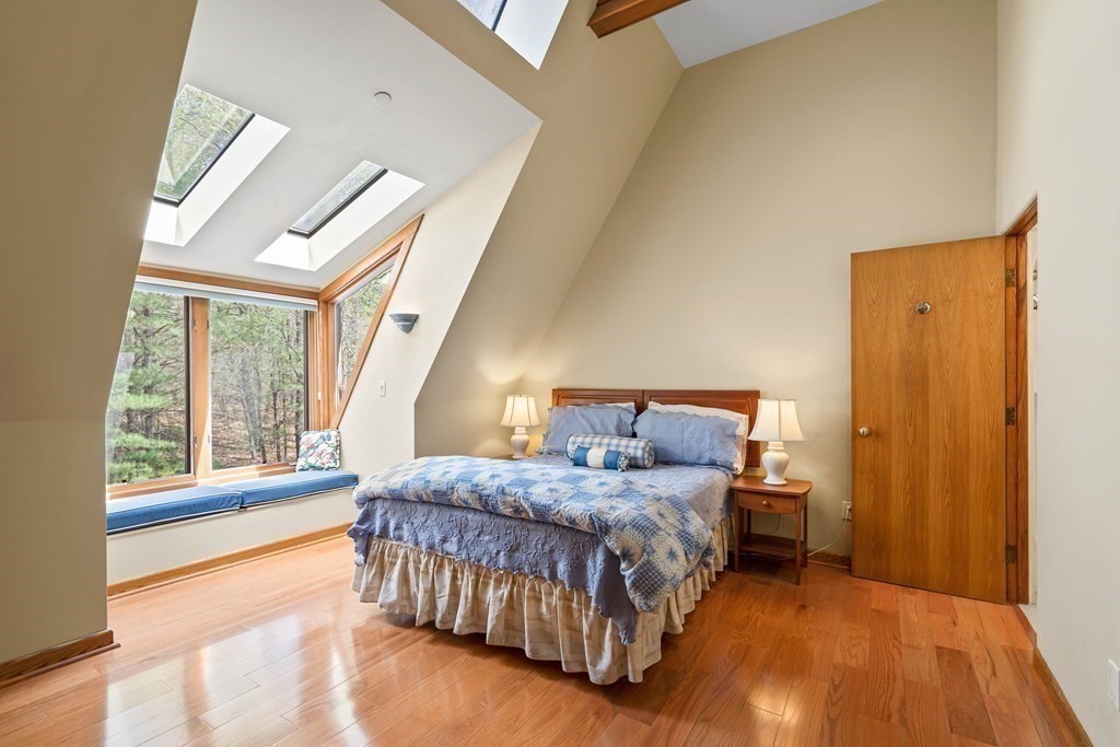 44 Sears Road Southborough, MA 01772 - Photo 31 of 41 a bedroom with a bed lamp and a large window with wooden floor