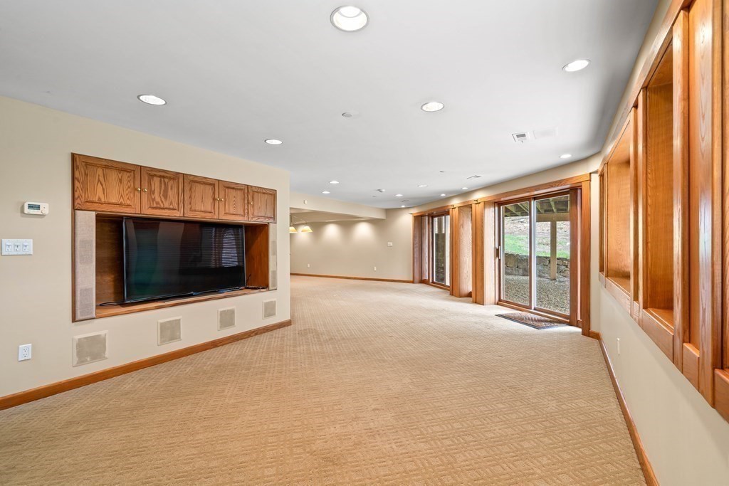 44 Sears Road Southborough, MA 01772 - Photo 37 of 41 a view of an empty room with a flat screen tv and floor to ceiling window