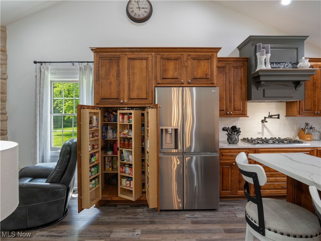 426 Bostic Road Gallipolis, OH 45631 - Photo 18 of 45 Kitchen with appliances with stainless steel finishes, lofted ceiling, a desk, decorative backsplash, and dark wood-type flooring