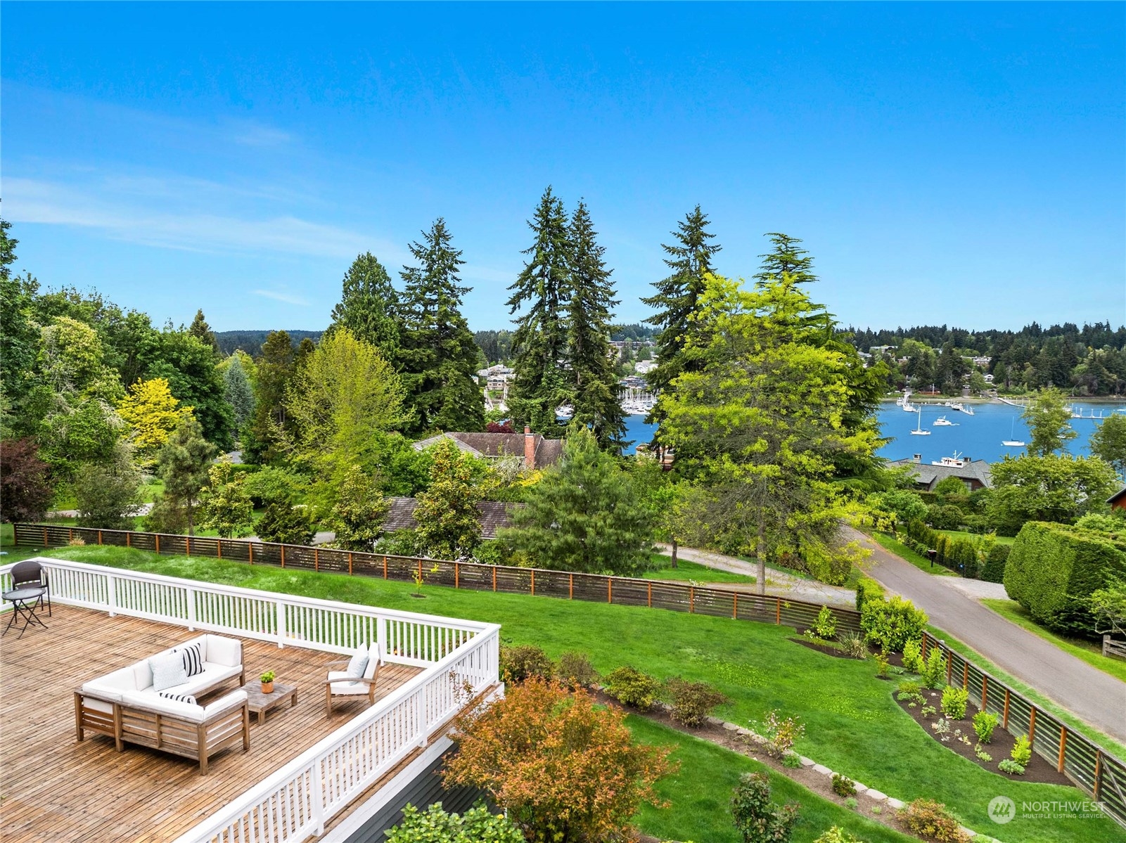 6024 Rose Loop Northeast Bainbridge Island, WA 98110 - Photo 1 of 40 a view of a patio with couches table and chairs with mountain view