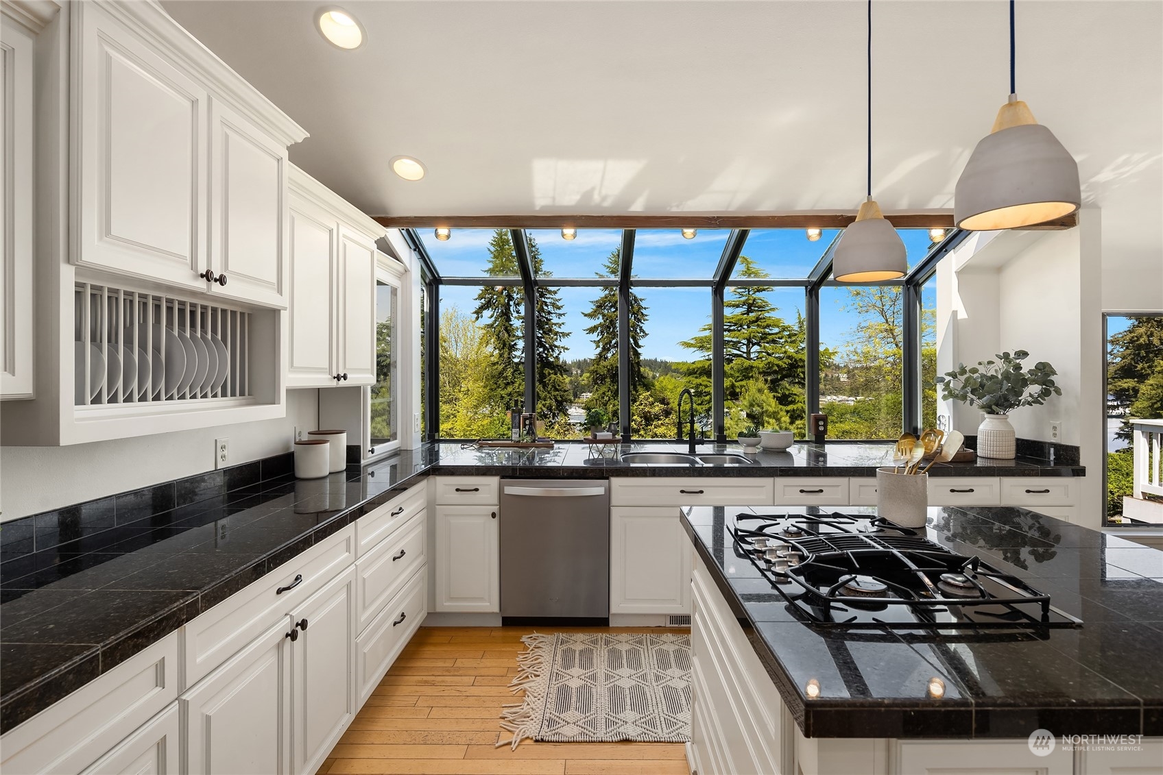6024 Rose Loop Northeast Bainbridge Island, WA 98110 - Photo 11 of 40 a kitchen with stainless steel appliances a stove a sink and a white wooden cabinets