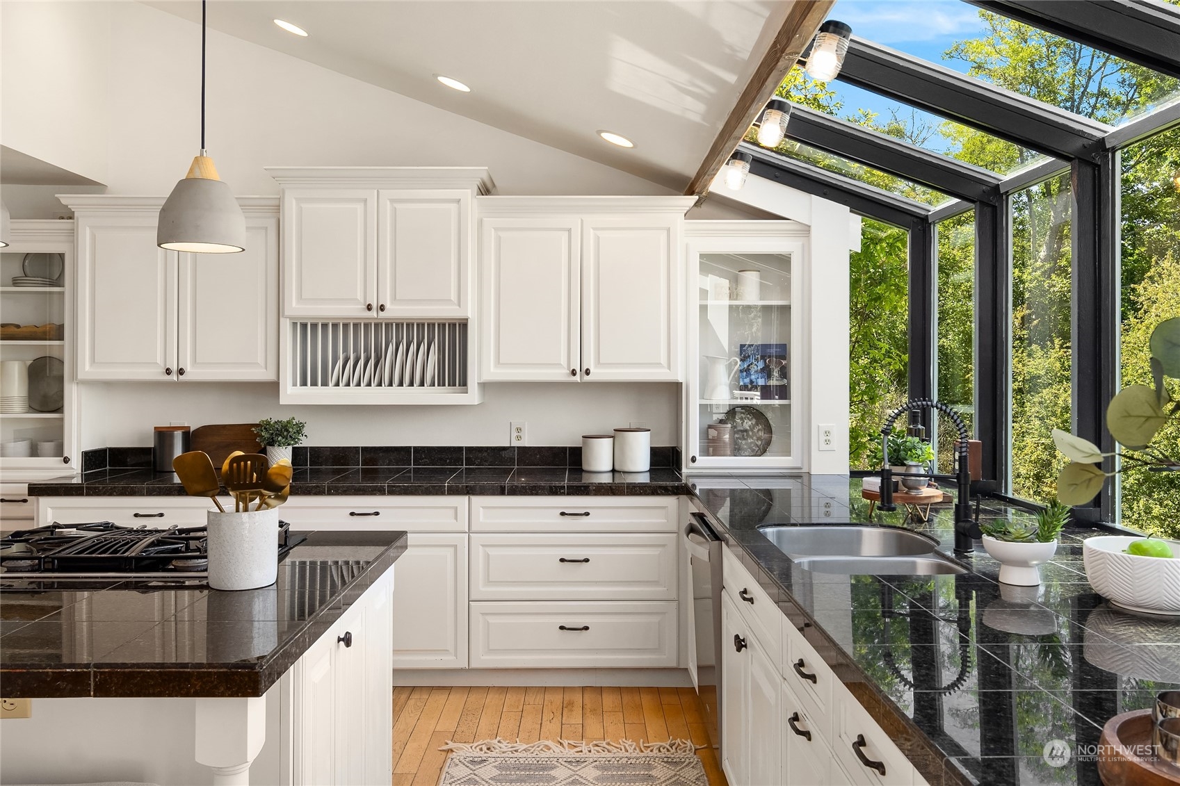 6024 Rose Loop Northeast Bainbridge Island, WA 98110 - Photo 12 of 40 a kitchen with granite countertop a sink a counter space appliances and cabinets