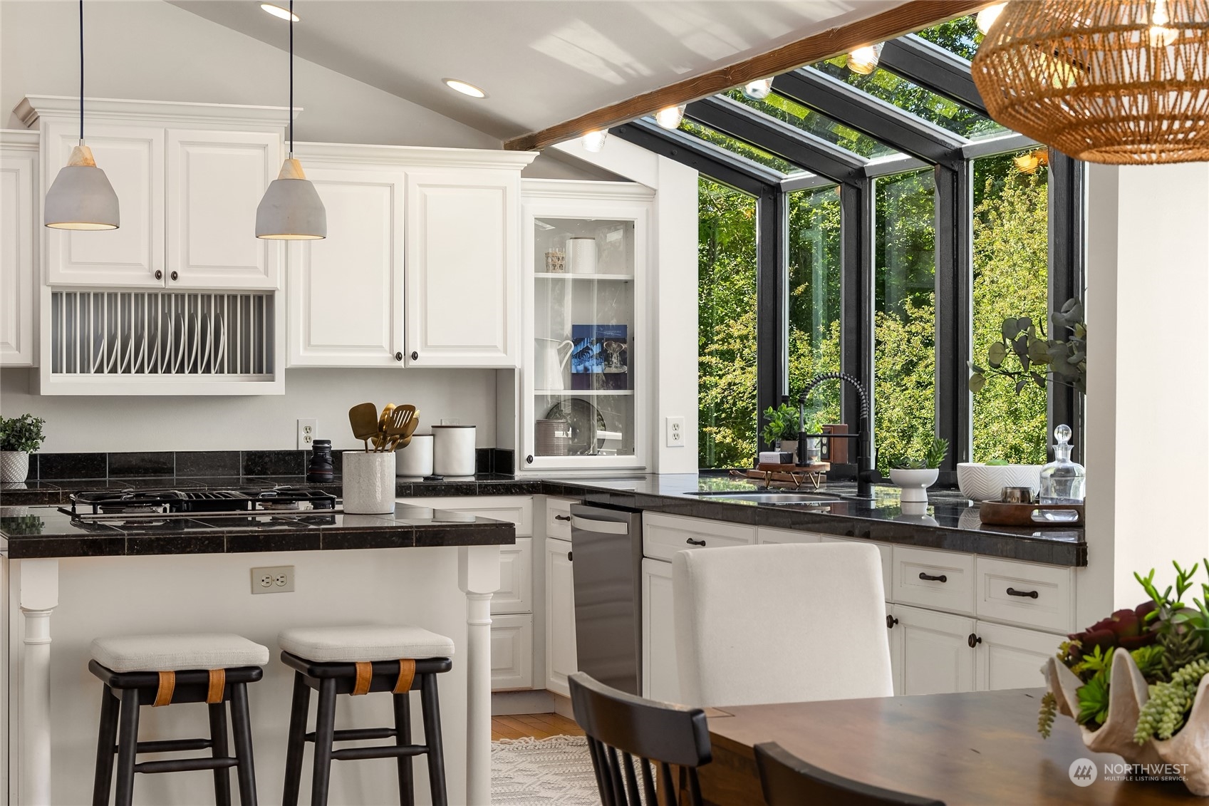 6024 Rose Loop Northeast Bainbridge Island, WA 98110 - Photo 14 of 40 a kitchen with stainless steel appliances granite countertop a stove a sink a refrigerator white cabinets and a dining table with garden view