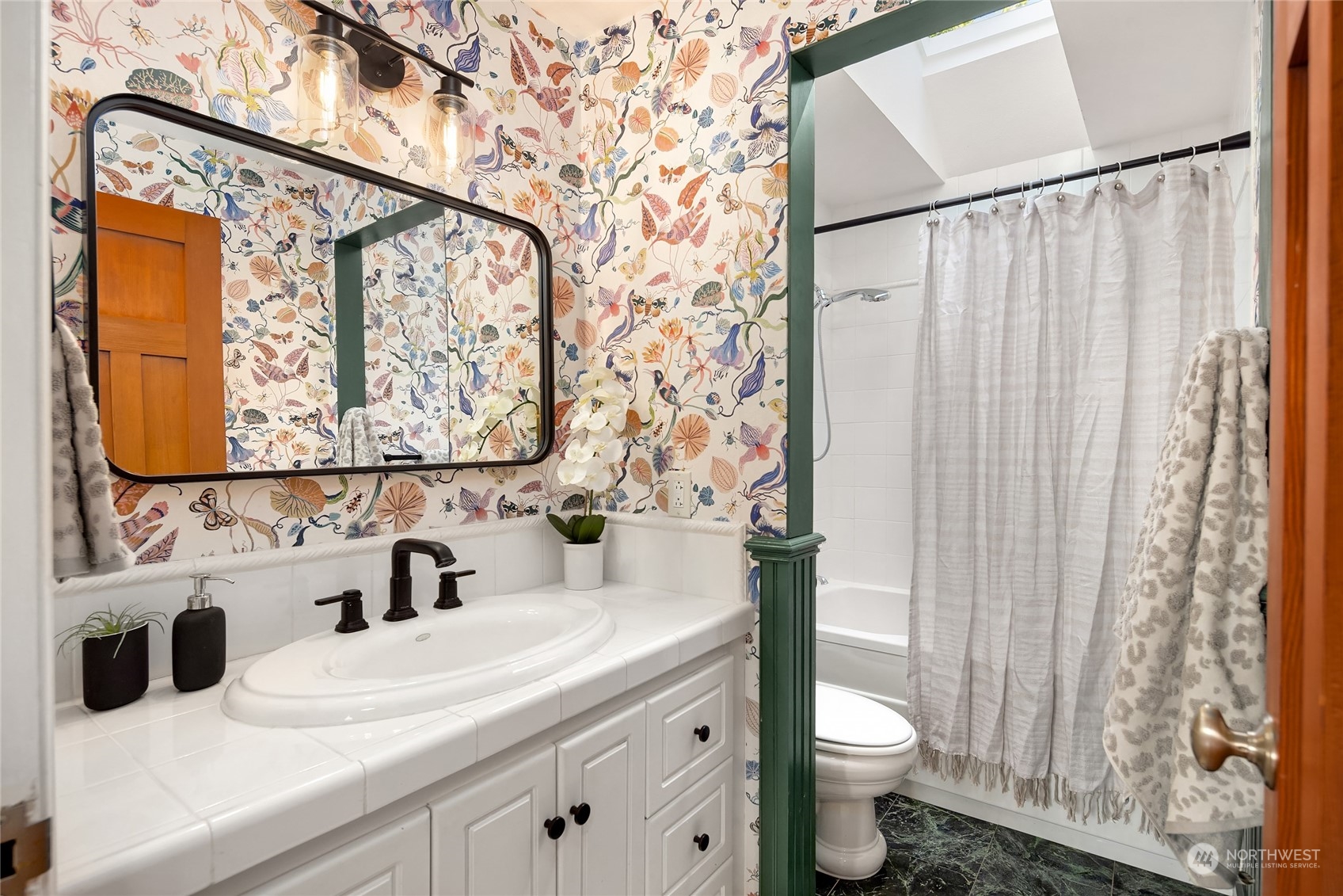 6024 Rose Loop Northeast Bainbridge Island, WA 98110 - Photo 20 of 40 a bathroom with a sink and a mirror