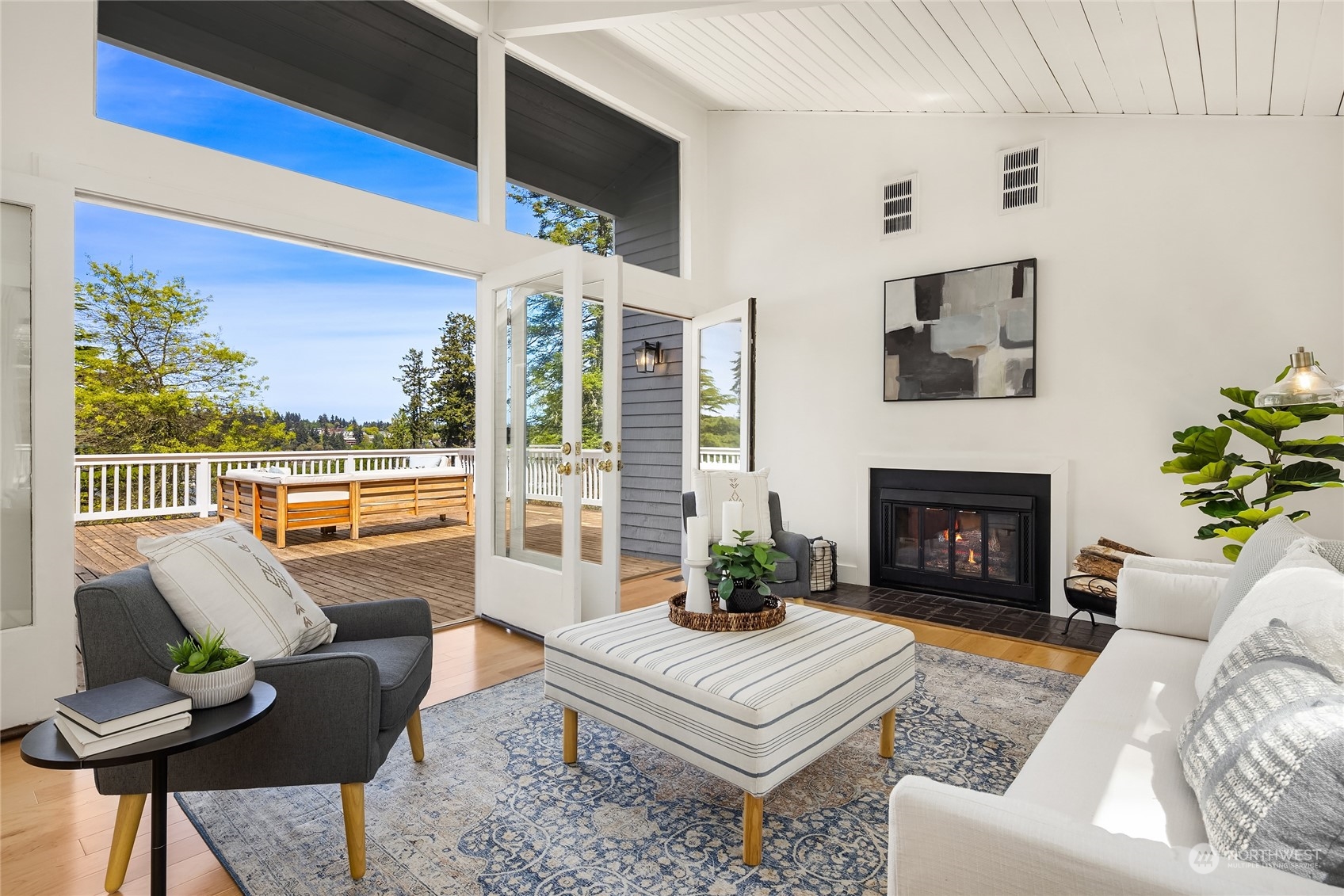 6024 Rose Loop Northeast Bainbridge Island, WA 98110 - Photo 2 of 40 a living room with furniture a fireplace and a floor to ceiling window